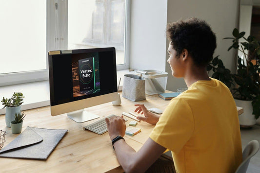 Person using a computer at a desk with a bright window in the background