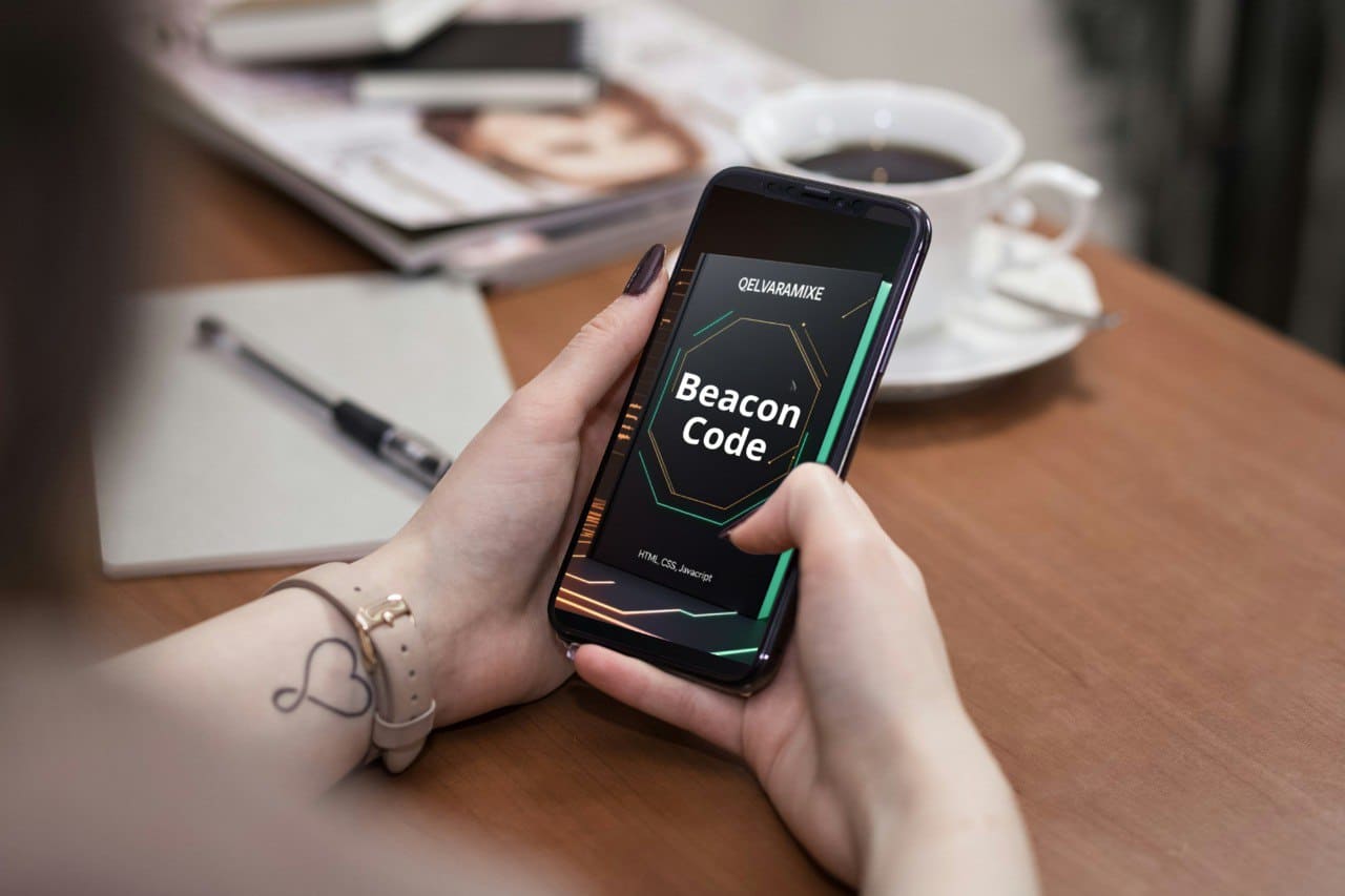 Person holding a smartphone with 'Beacon Code' course on a table with coffee and magazine.