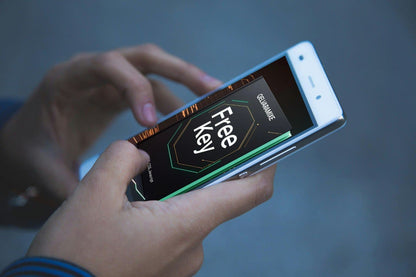Hand holding a smartphone with a 'Free Key' course displayed on the screen against a blurred background