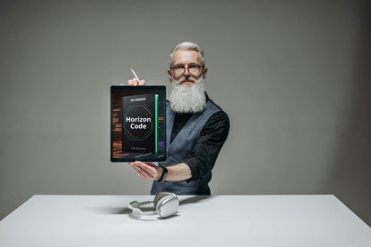 Man holding a tablet with 'Horizon Code' course displayed, sitting at a table against a gray background